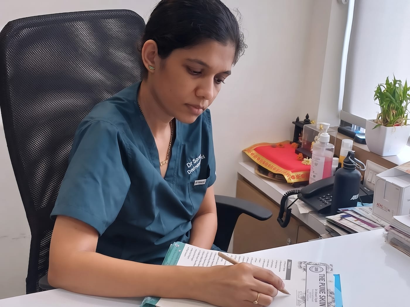 Dr. Sonam Tayde reviewing a treatment plan at The Pune Skin Clinic