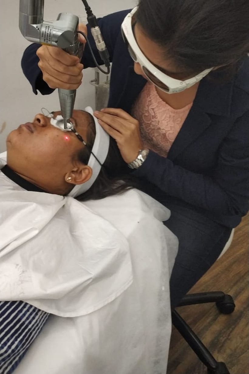 Dr. Sonam Tayde performing a laser treatment at the clinic