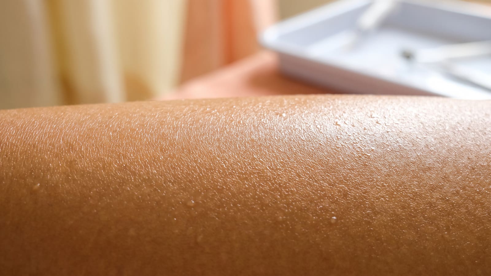 Macro close-up of smooth, healthy Indian skin texture in warm light